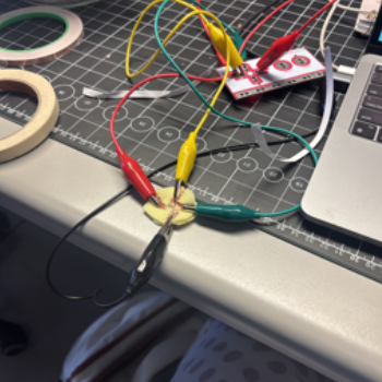 I connected some conductive tape to a circle of felt and connected it with my hands.