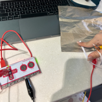 I used the black wire (grounding wire) on the conductive cloth, the red wire on the paper (with conductive tape) and connected the two to complete the circuit. 
